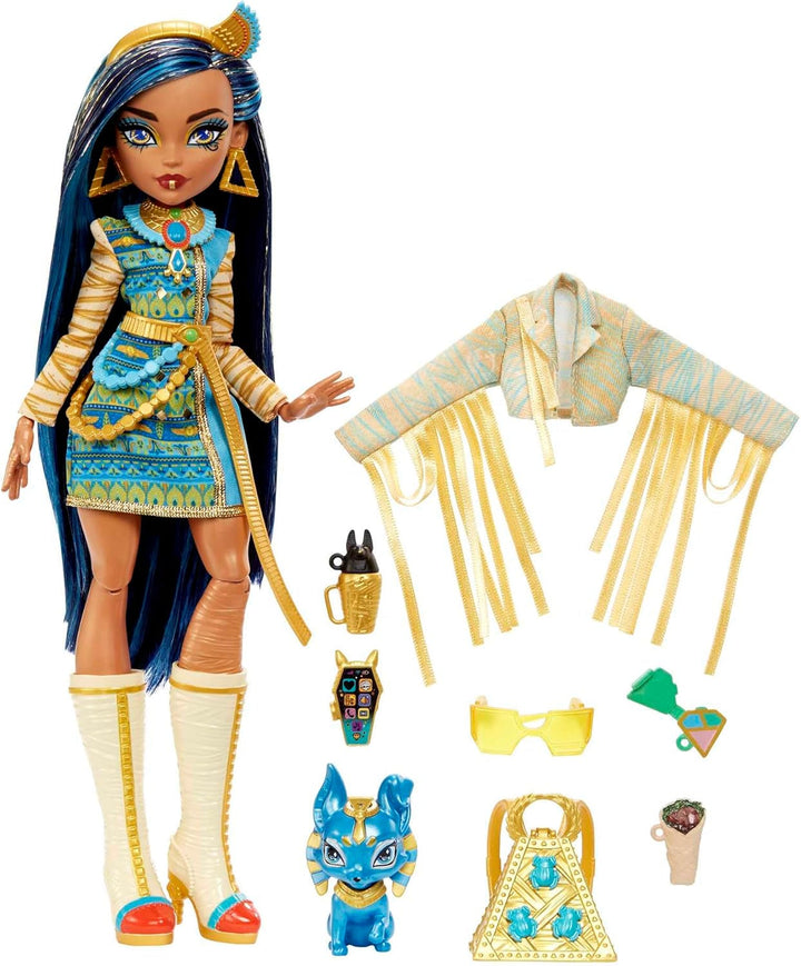 Păpușă Monster High Cleo De Nile în bluză aurie și fustă stratificată, include animal de companie Cobra Hissette și accesorii precum rucsac, gustare și rolă de hârtie, HXH74